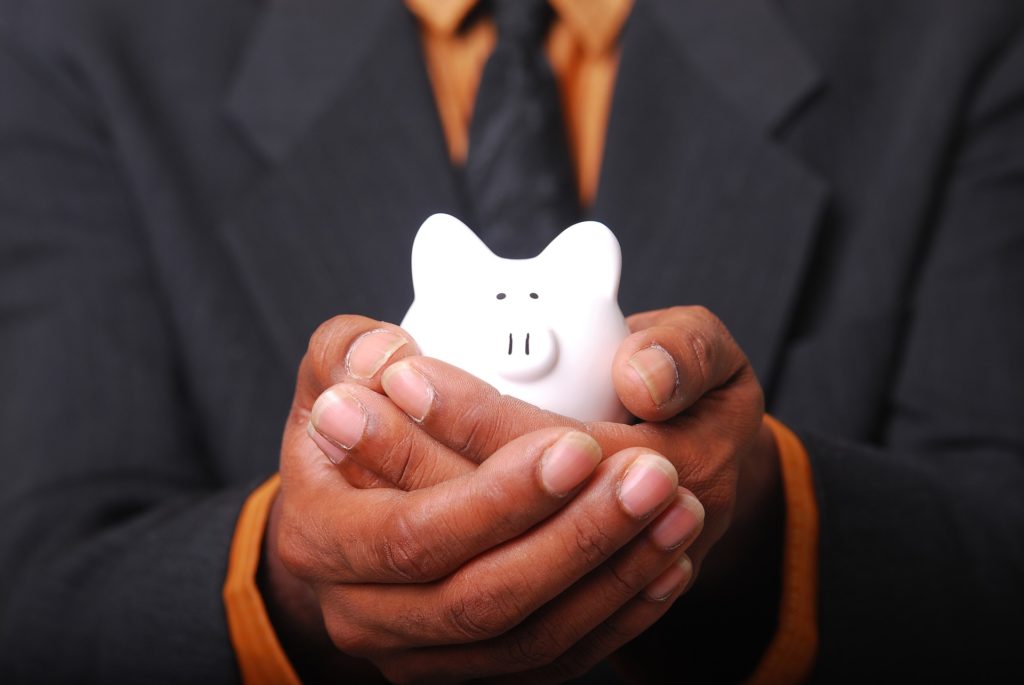 Man holding piggy bank, symbolic of consolidating debt